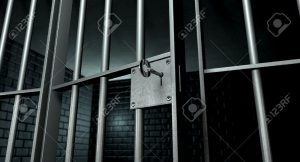 14582730-a-closeup-of-the-lock-of-a-brick-jail-cell-with-iron-bars-and-a-key-in-the-locking-mechanism-with-th-stock-photo